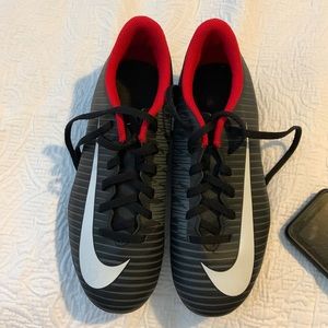 For sale is a black with white trim Nike Soccer cleats size Youth 5.5